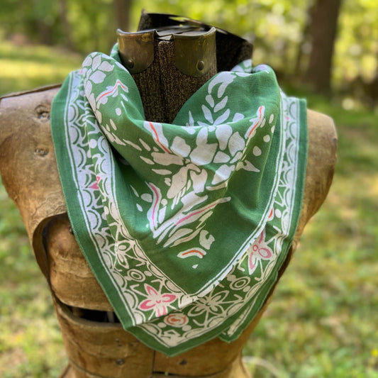 Green bandana with white floral patterns outdoors