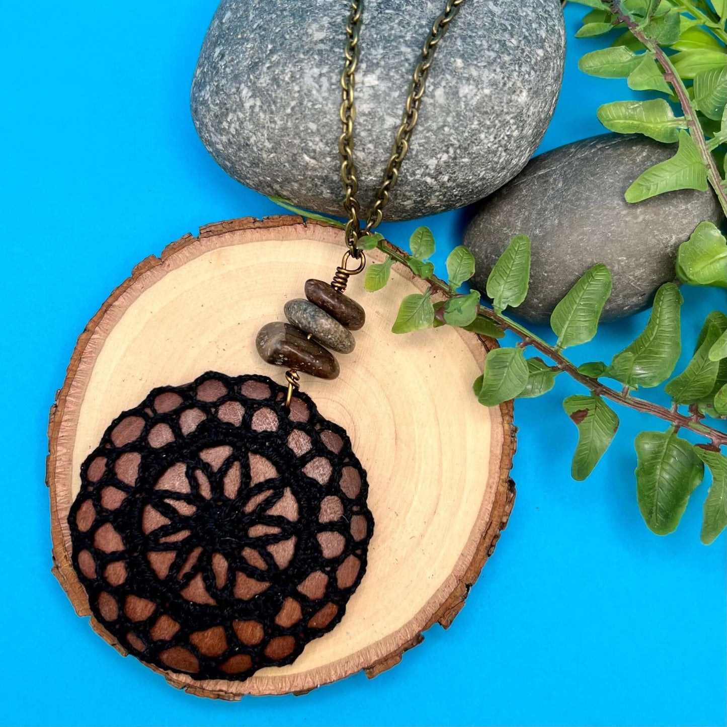black crocheted pendant necklace on long chain