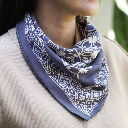 Person wearing a blue and white patterned scarf