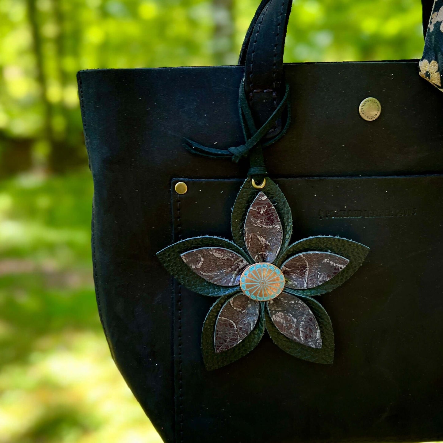 black leather flower bag charm on black purse