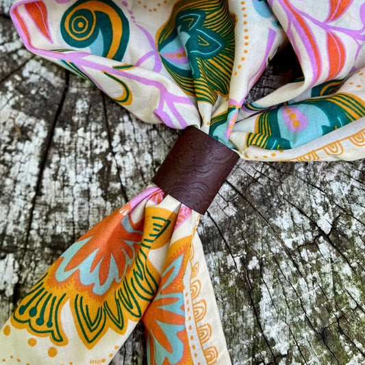 dark brown leather bandana slide with embossed floral pattern on floral scarf