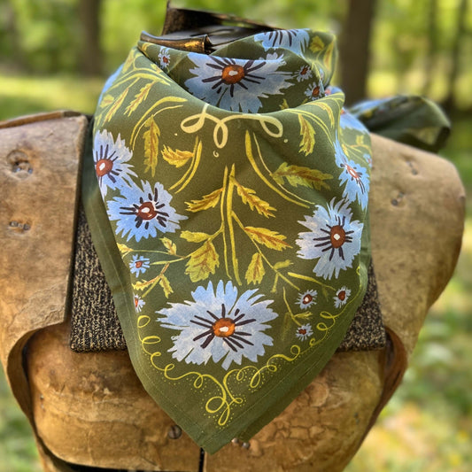 Floral-patterned bandana draped over a wooden object with a natural background