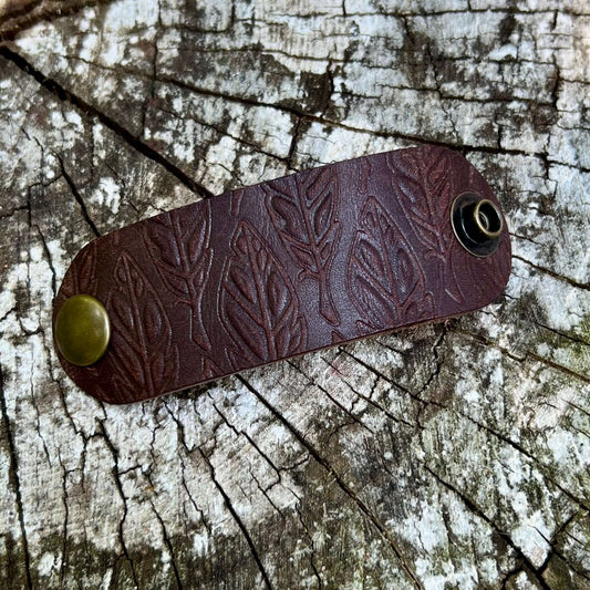 dark brown leather bandana slide embossed with feathers