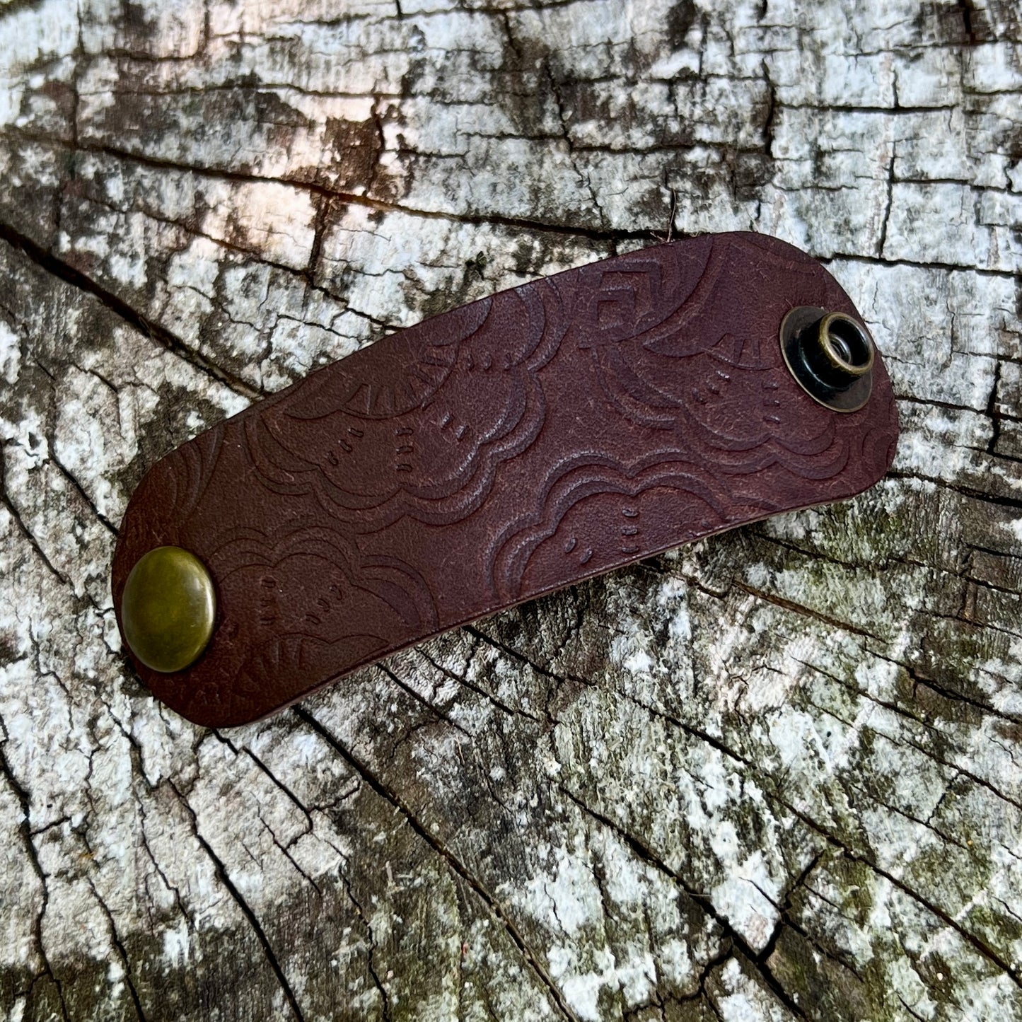 dark brown leather bandana slide with embossed floral pattern