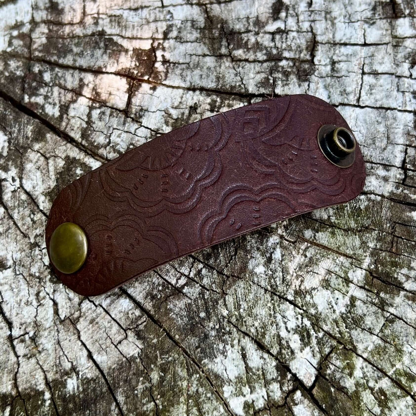 dark brown leather bandana slide with embossed floral pattern
