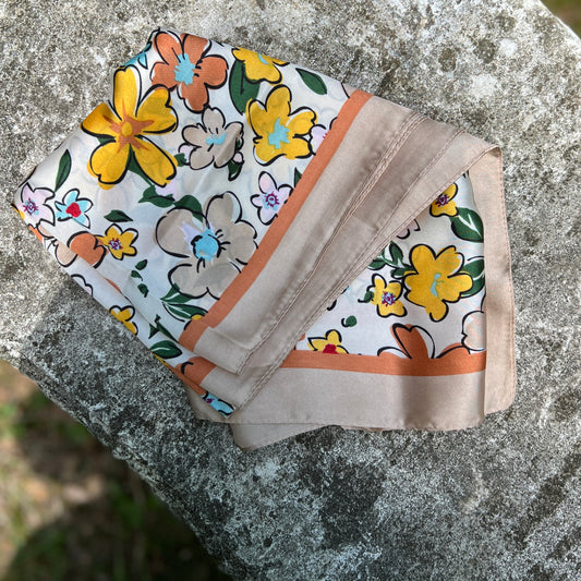 Floral silky scarf on a stone surface
