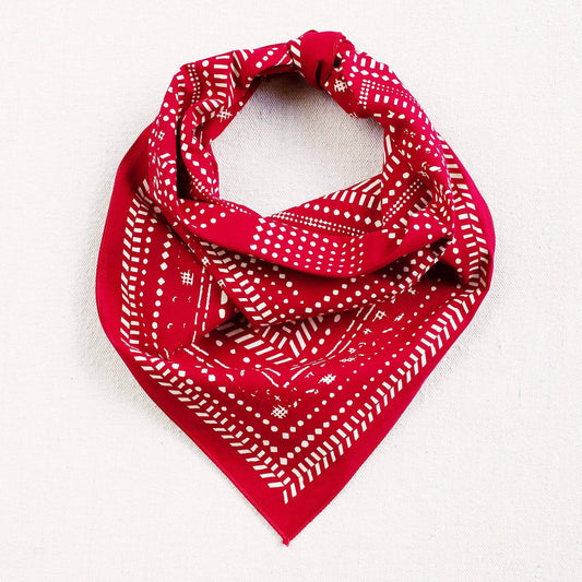 Red bandana with white patterns on a white background