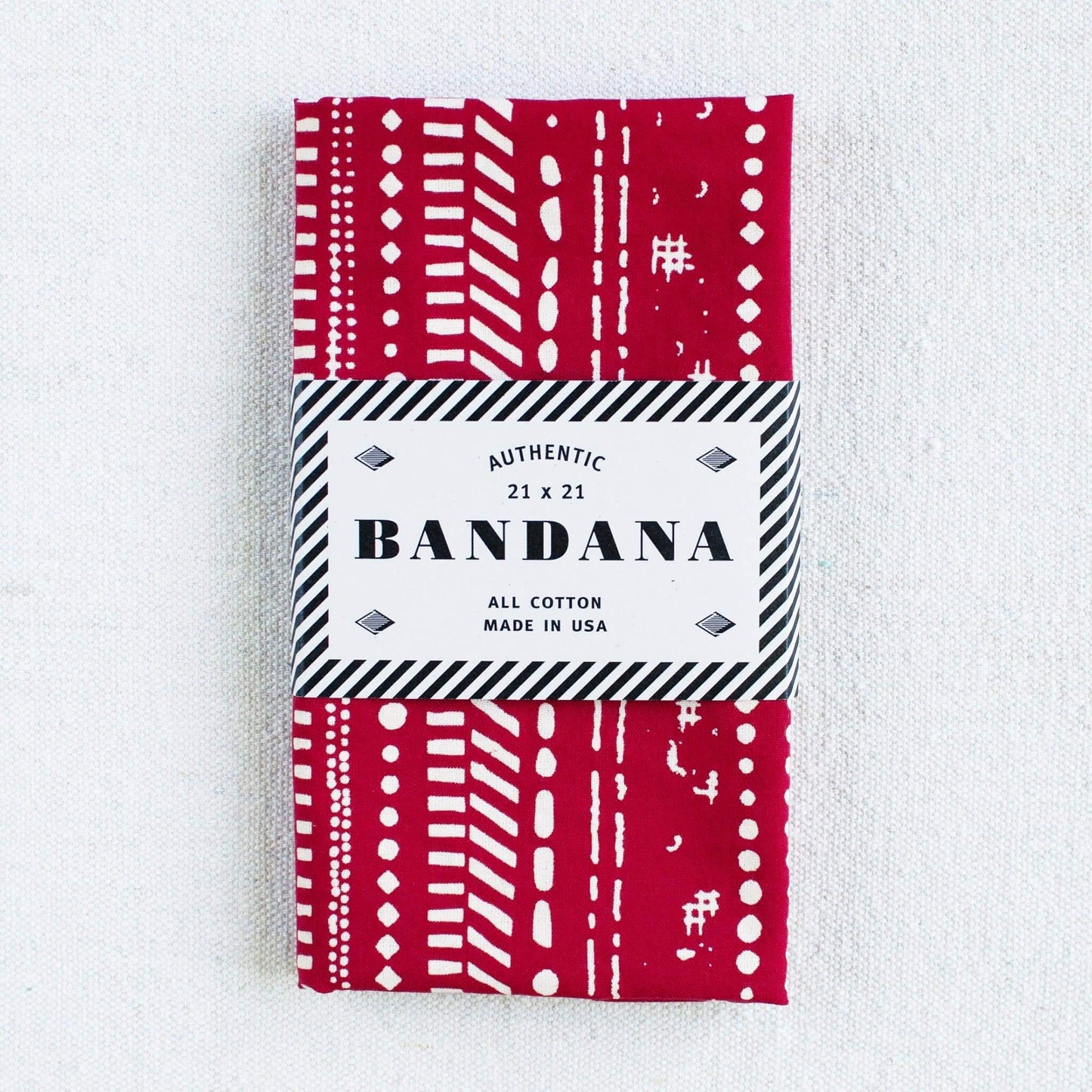 Red and white patterned bandana packaging on a white background