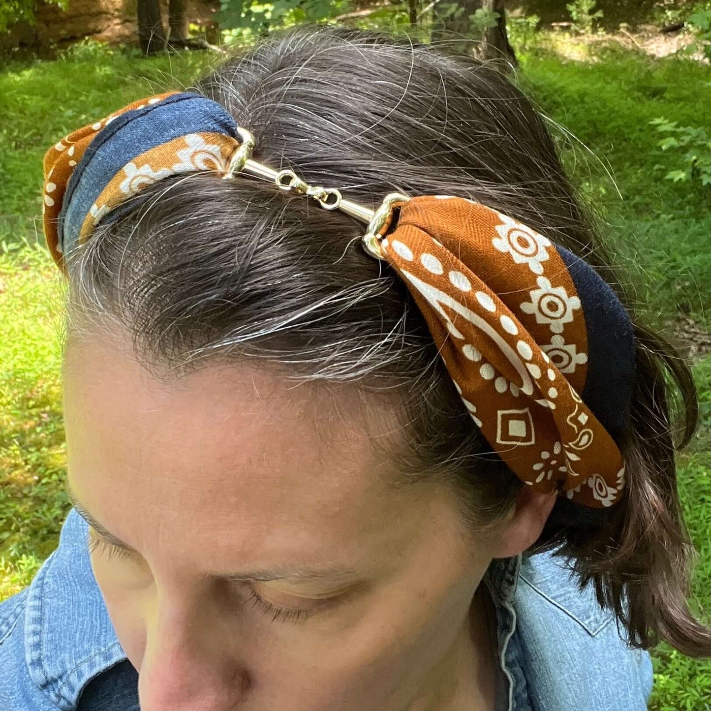 Person wearing a patterned headband outdoors