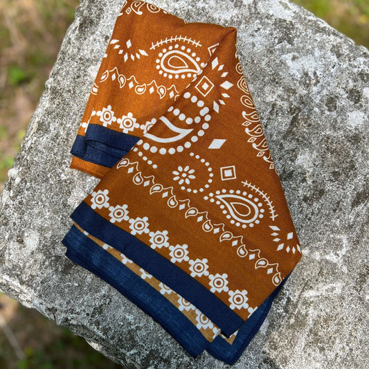 Brown bandana with white patterns on a stone surface