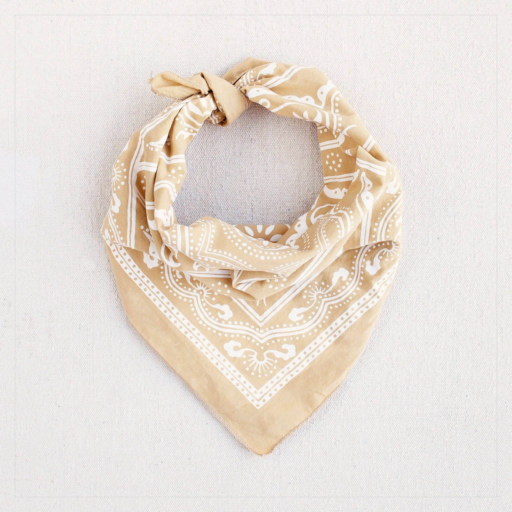 Beige bandana with white pattern on a light gray background