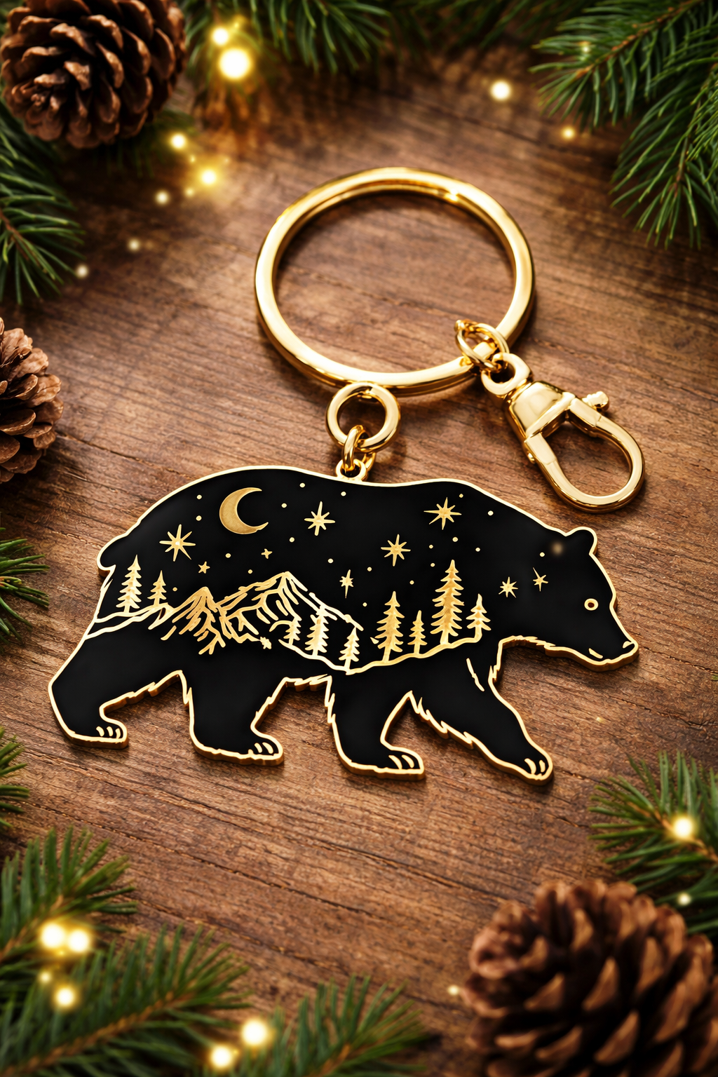 Keychain with bear design on a wooden surface with pine cones and lights