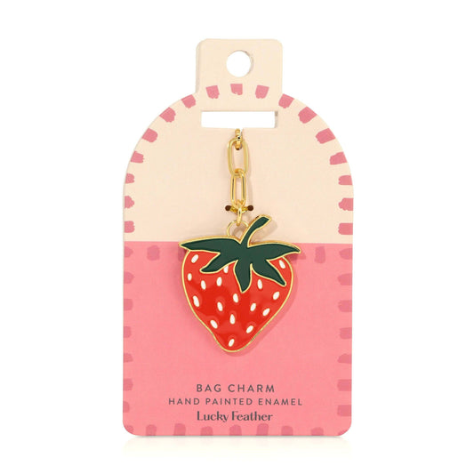 Strawberry-shaped bag charm on a pink and beige card with 'Lucky Feather' branding.