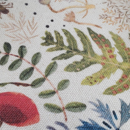 Close-up of a fabric with embroidered floral and leaf patterns.