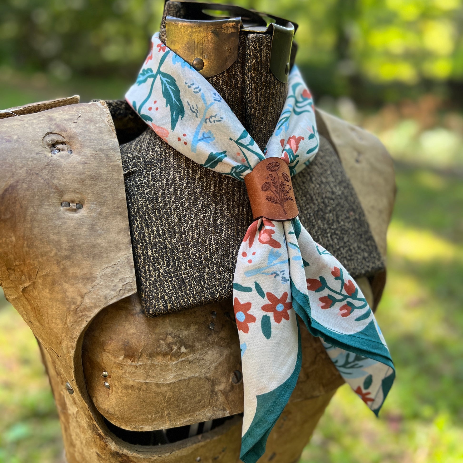 A floral cotton bandana with leather slide on vintage dress form