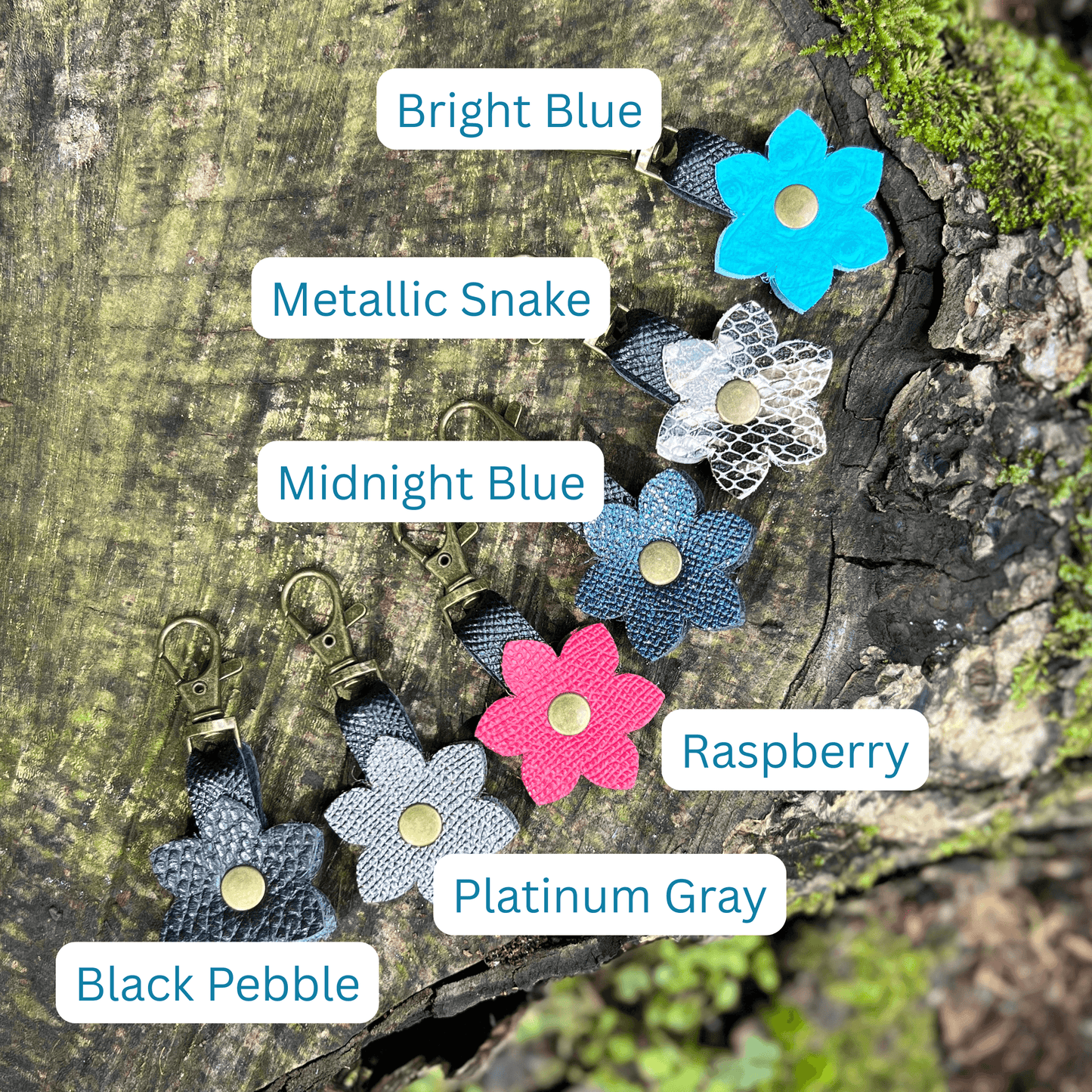 Flower-shaped keychains in various colors on a wooden surface