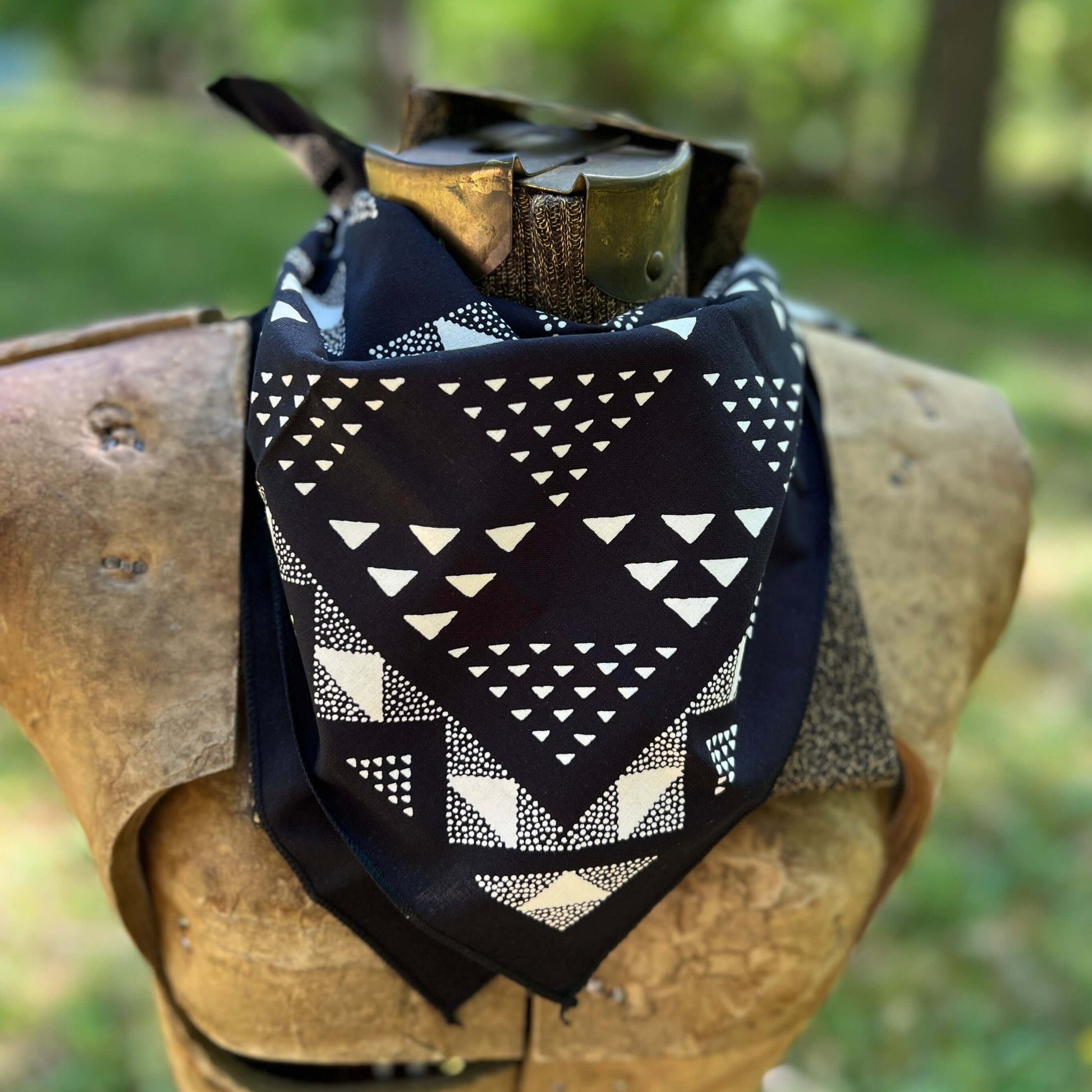 Black and white patterned bandana with a blurred green background