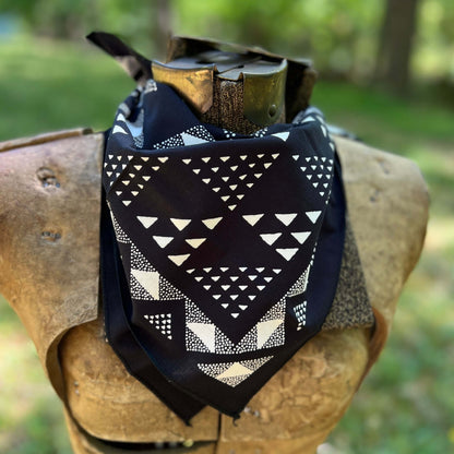 Black and white patterned bandana with a blurred green background
