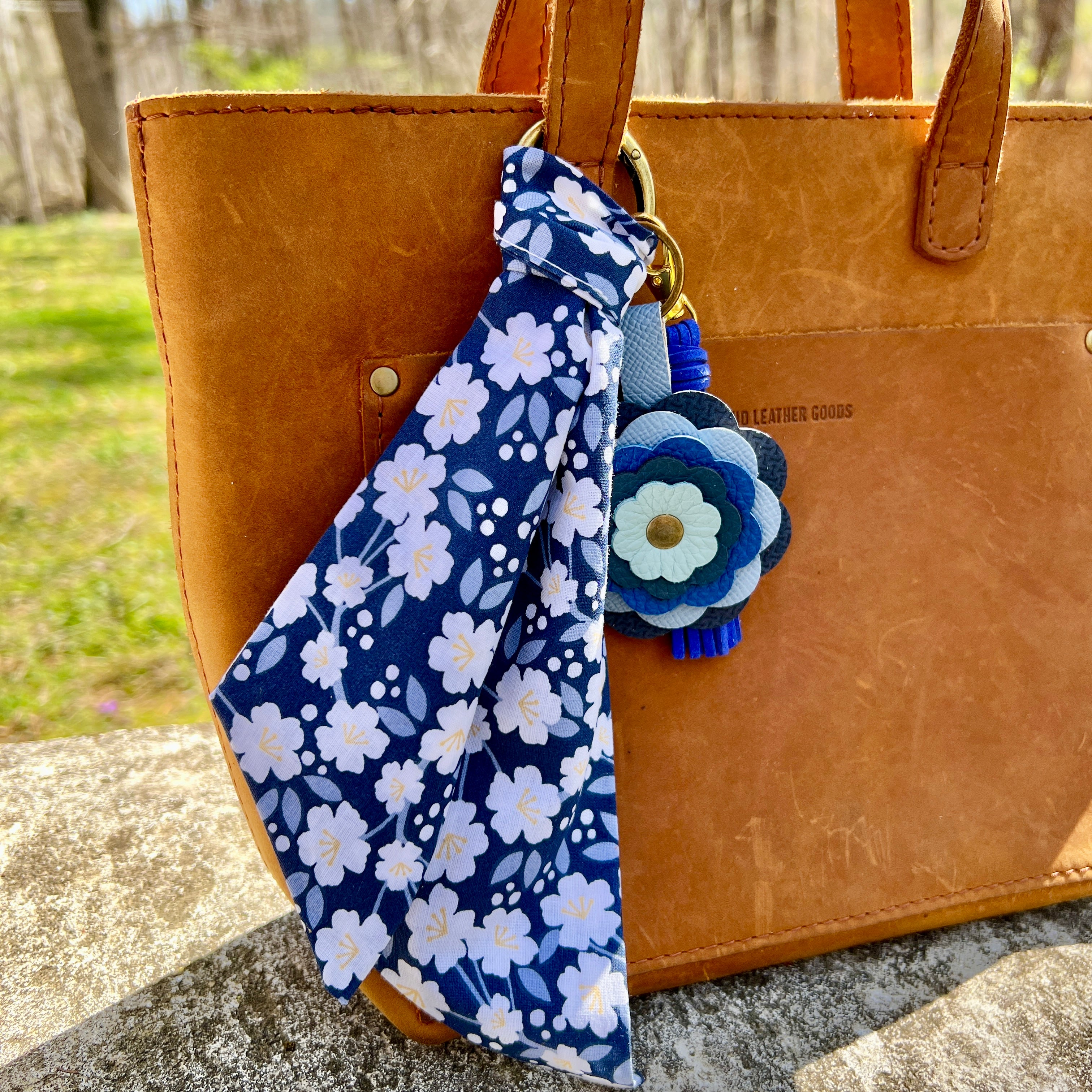 Blue Leather Flower Bag Charm and key chain with blue and white purse scarf on brown bag