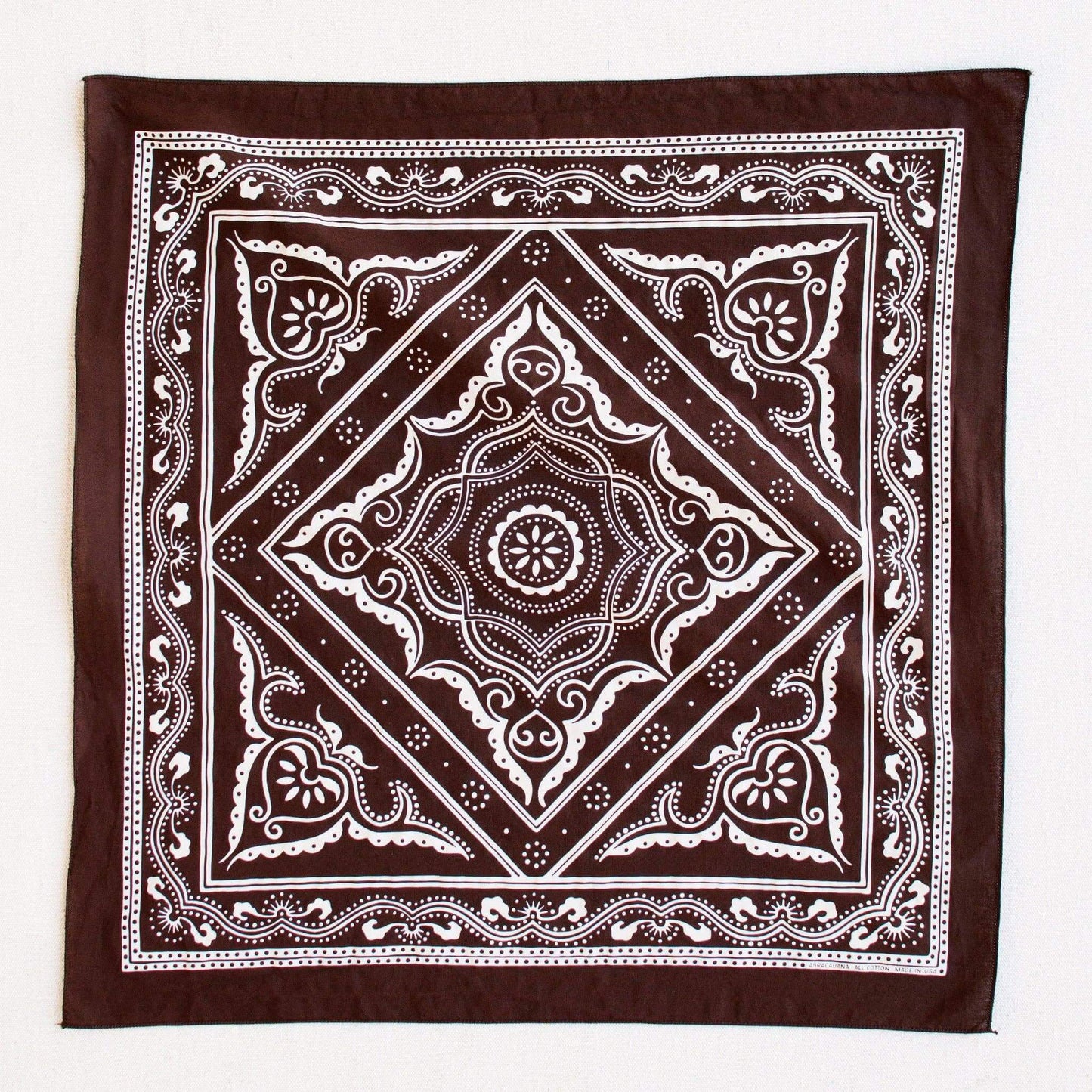 Brown bandana with white intricate patterns on a white background