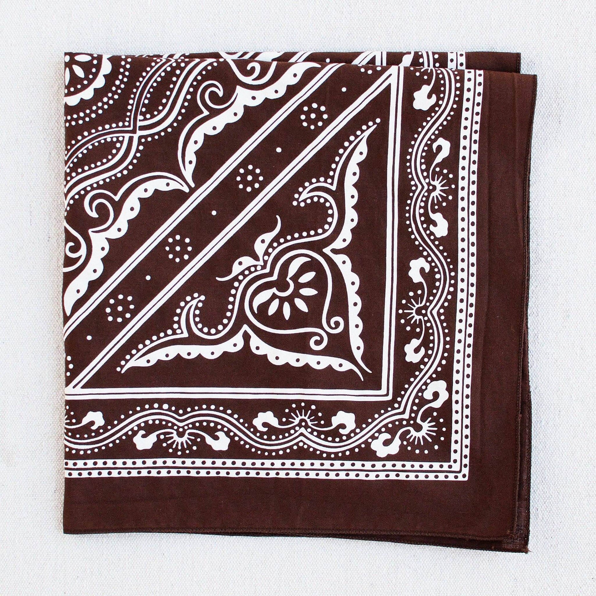 Brown bandana with white paisley pattern on a white background