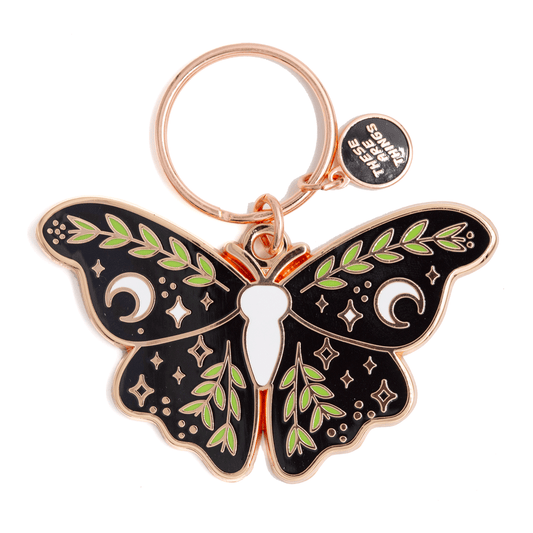 Butterfly-shaped keychain with decorative elements on a white background
