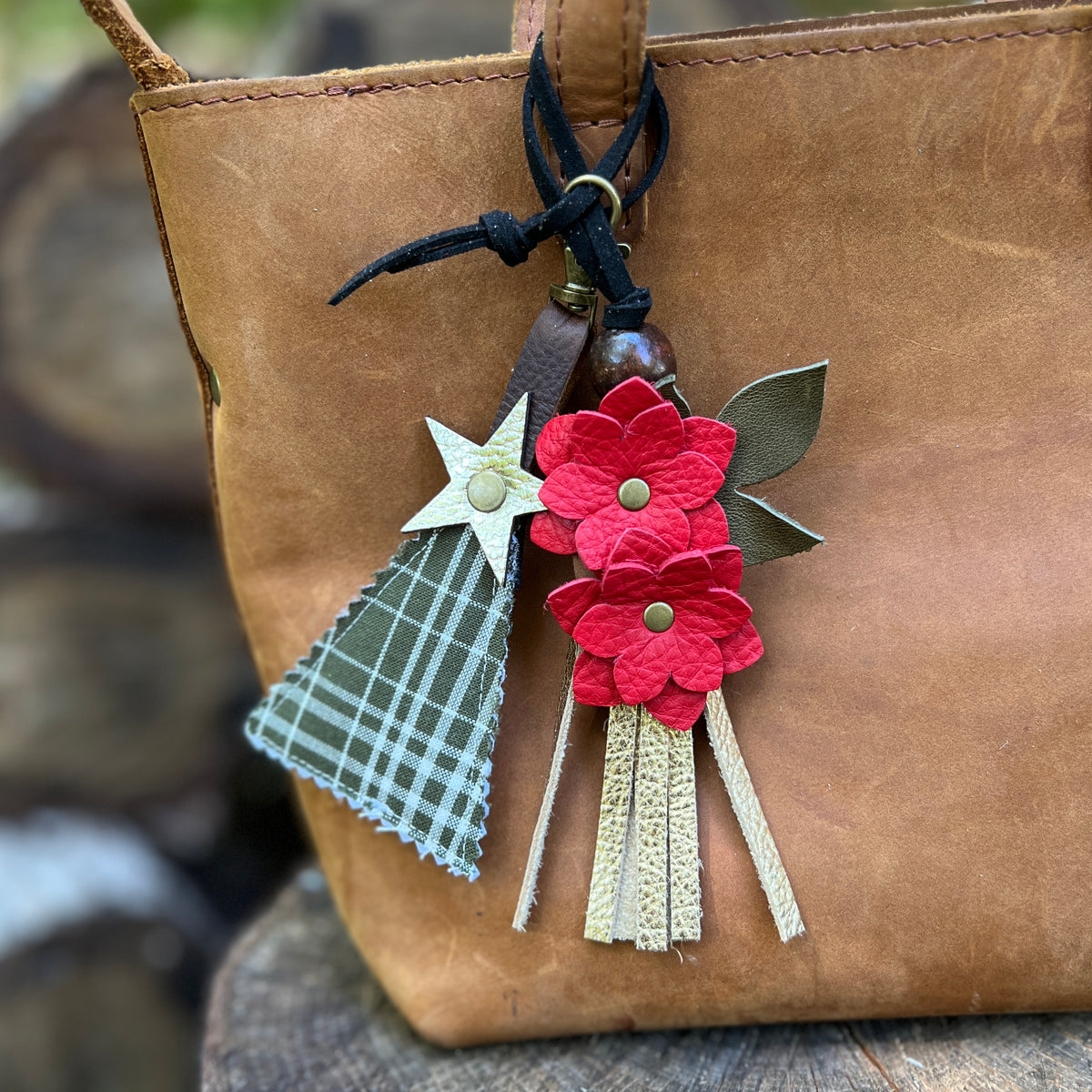 green plaid tree charm with red flower tassel charm on brown tote