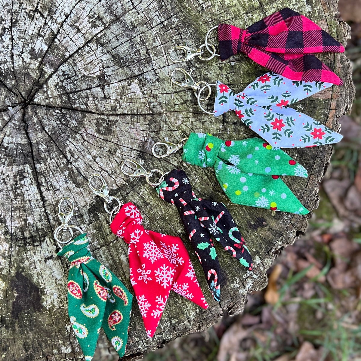 Christmas print mini scarf keychains on wooden surface