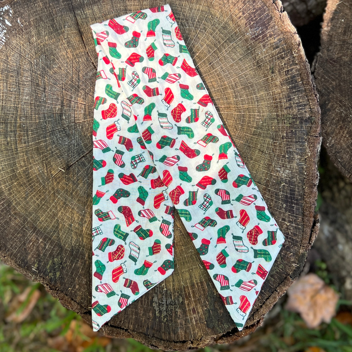 Christmas stocking print purse scarf on wooden surface