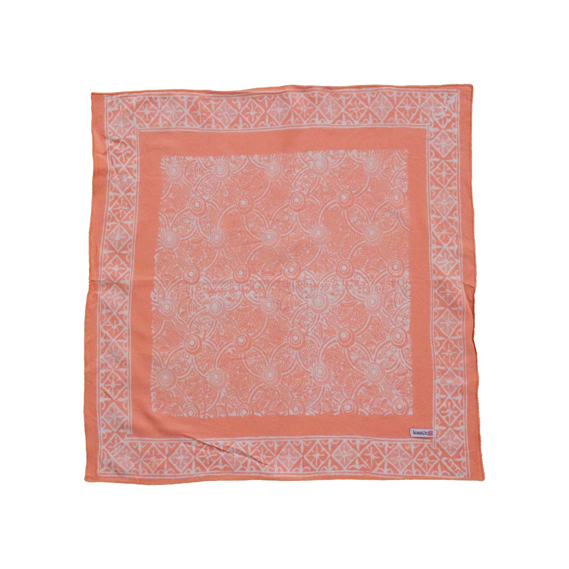 Coral bandana with white pattern on a white background
