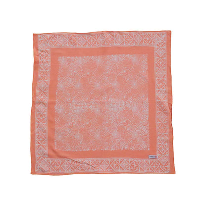 Coral bandana with white pattern on a white background