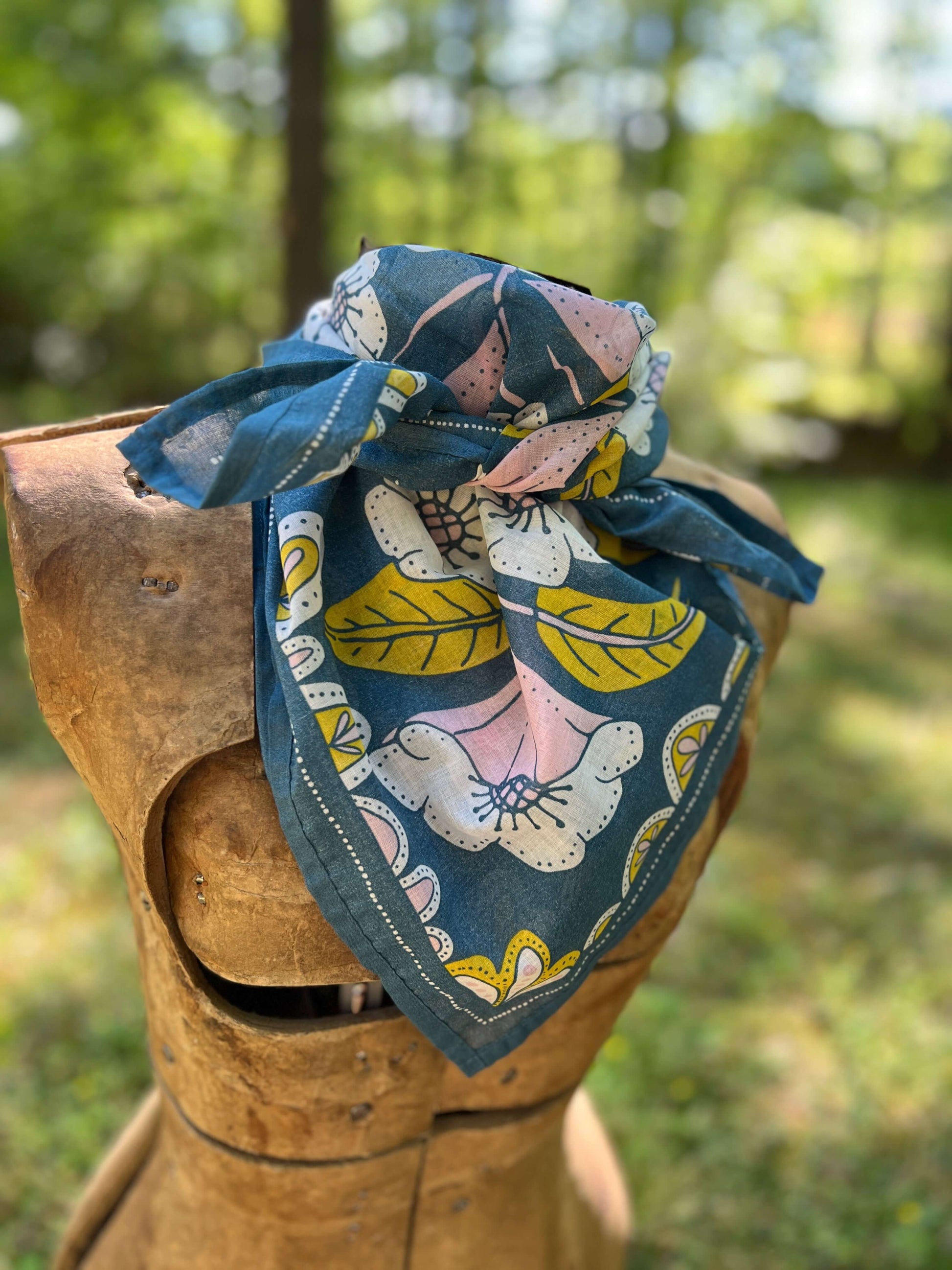 Fabric with floral pattern on a wooden block outdoors