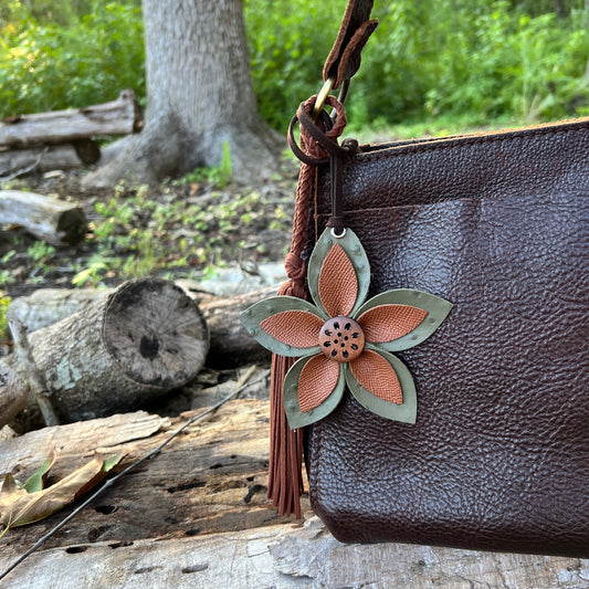 brown and olive green leather flower purse charm shoen on brown handbag with brown tassel