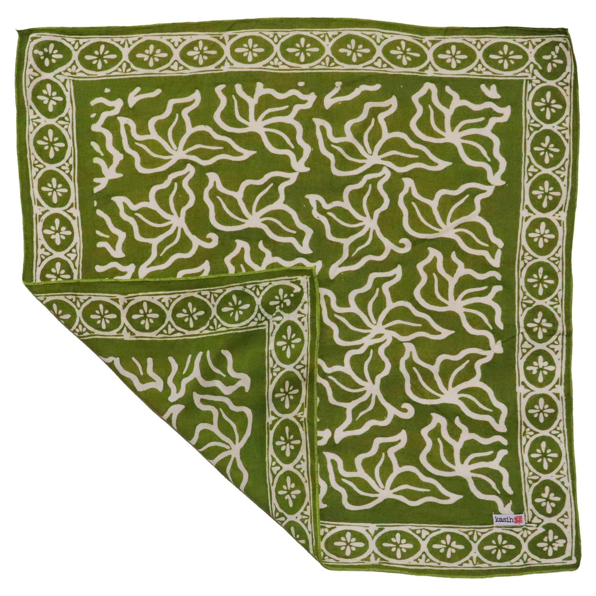 Green fabric with white floral pattern on a white background
