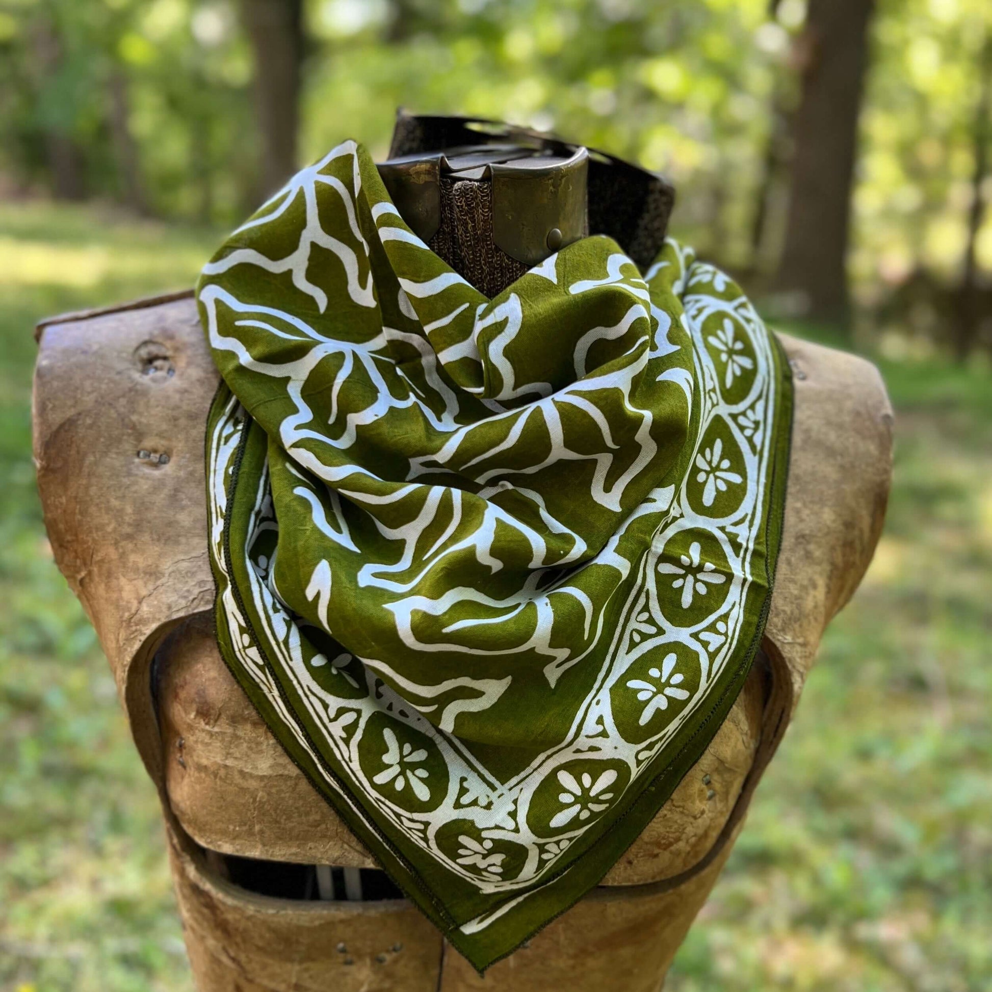 Green and white patterned bandana  in a forest setting