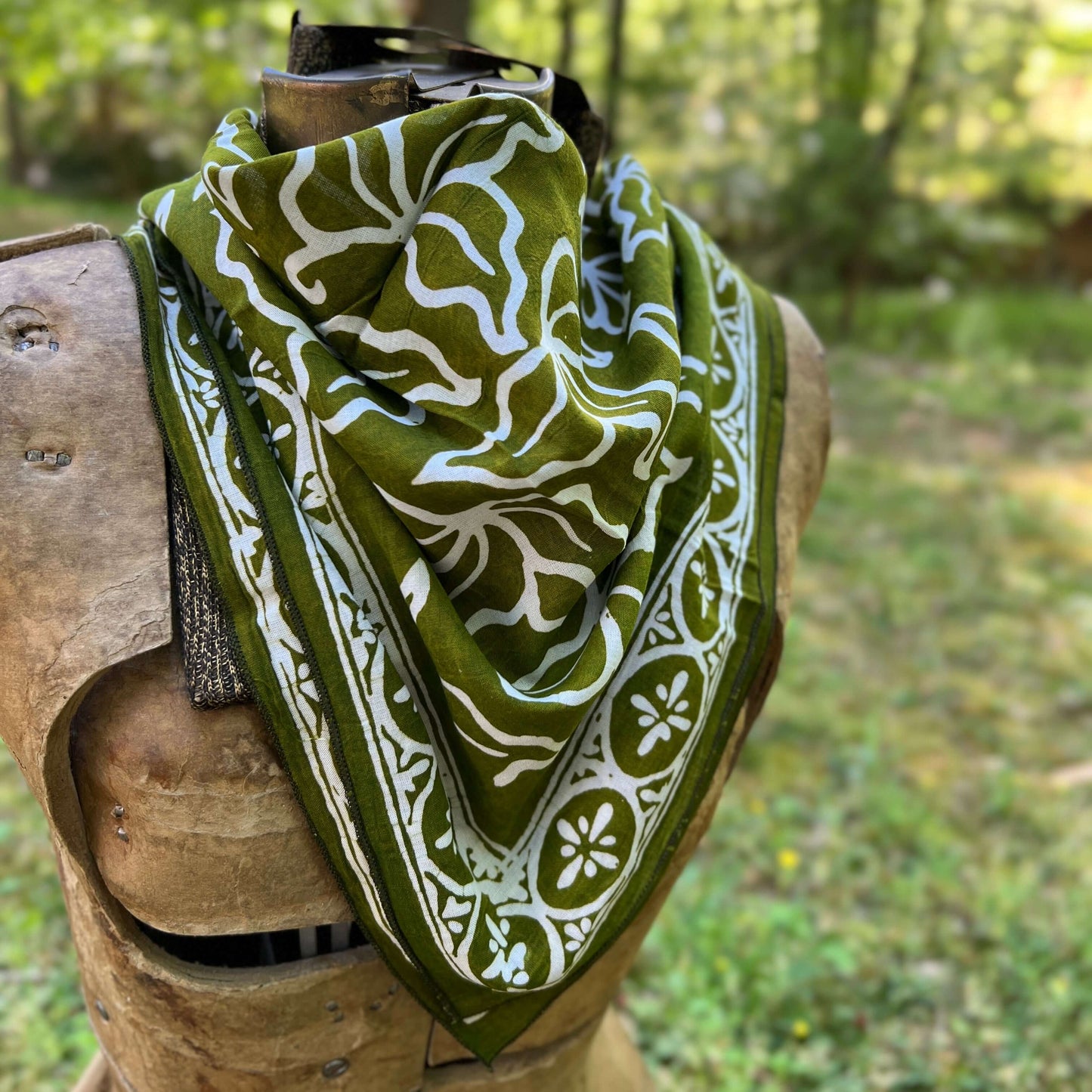 Green and white patterned bandana  in a forest setting