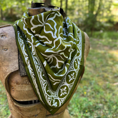 Green and white patterned bandana  in a forest setting