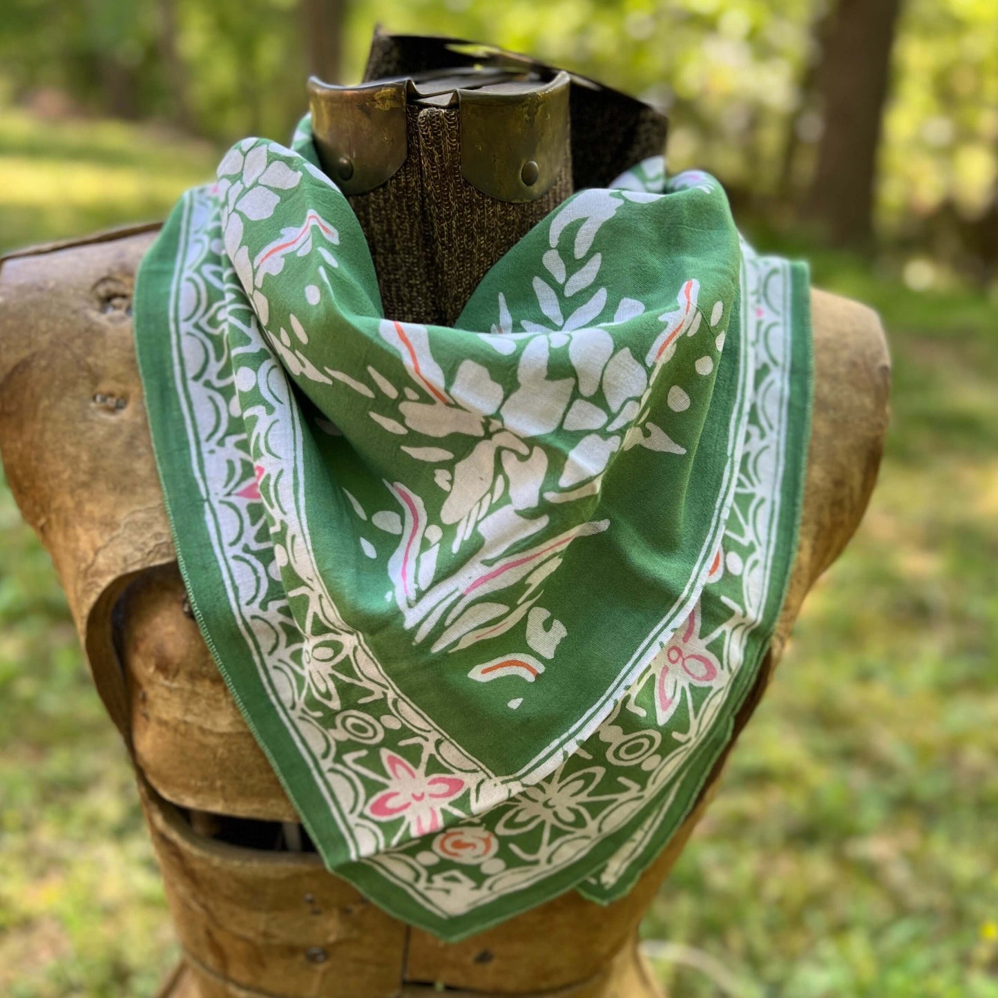 Green bandana with white floral patterns outdoors