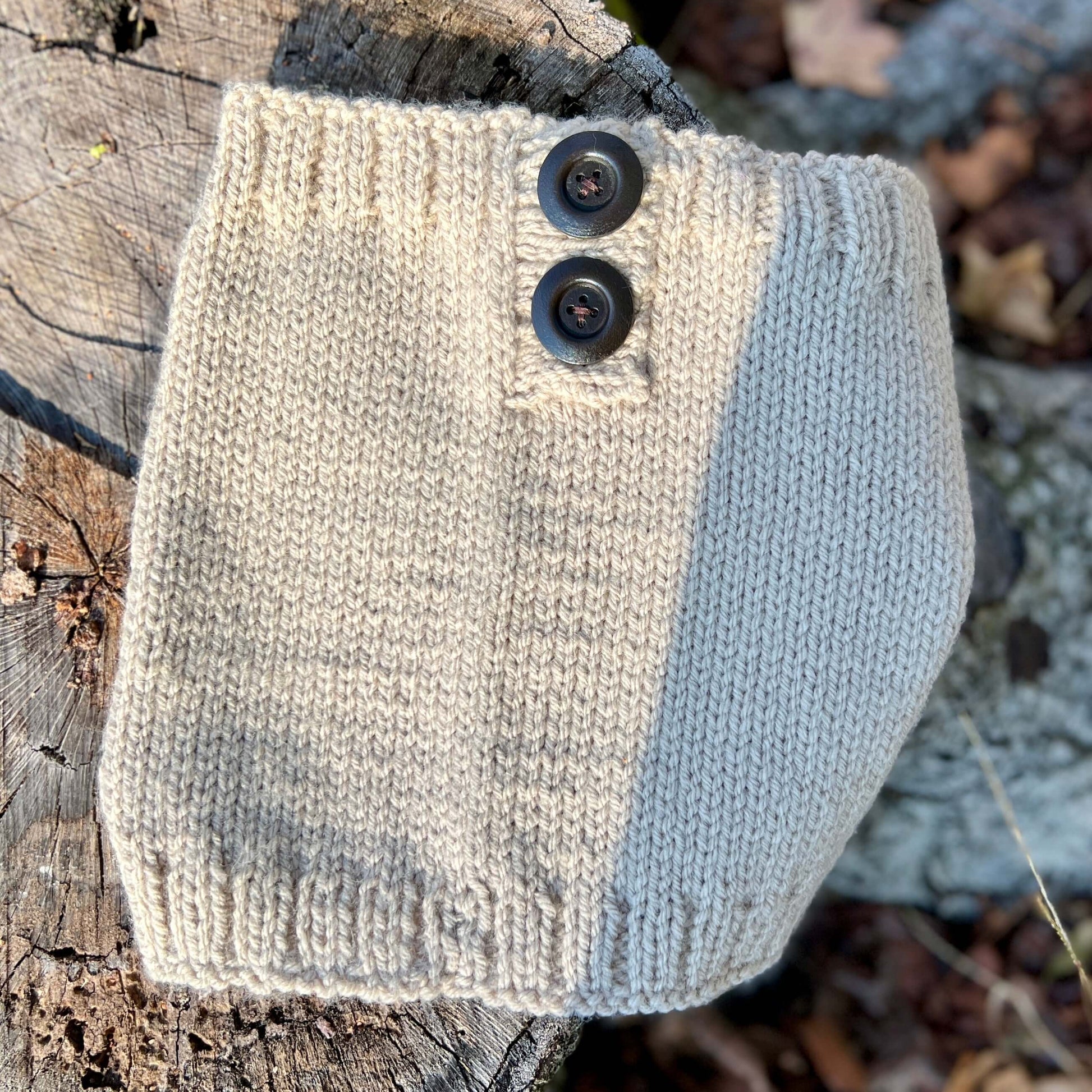 Knitted scarf with buttons on a wooden surface