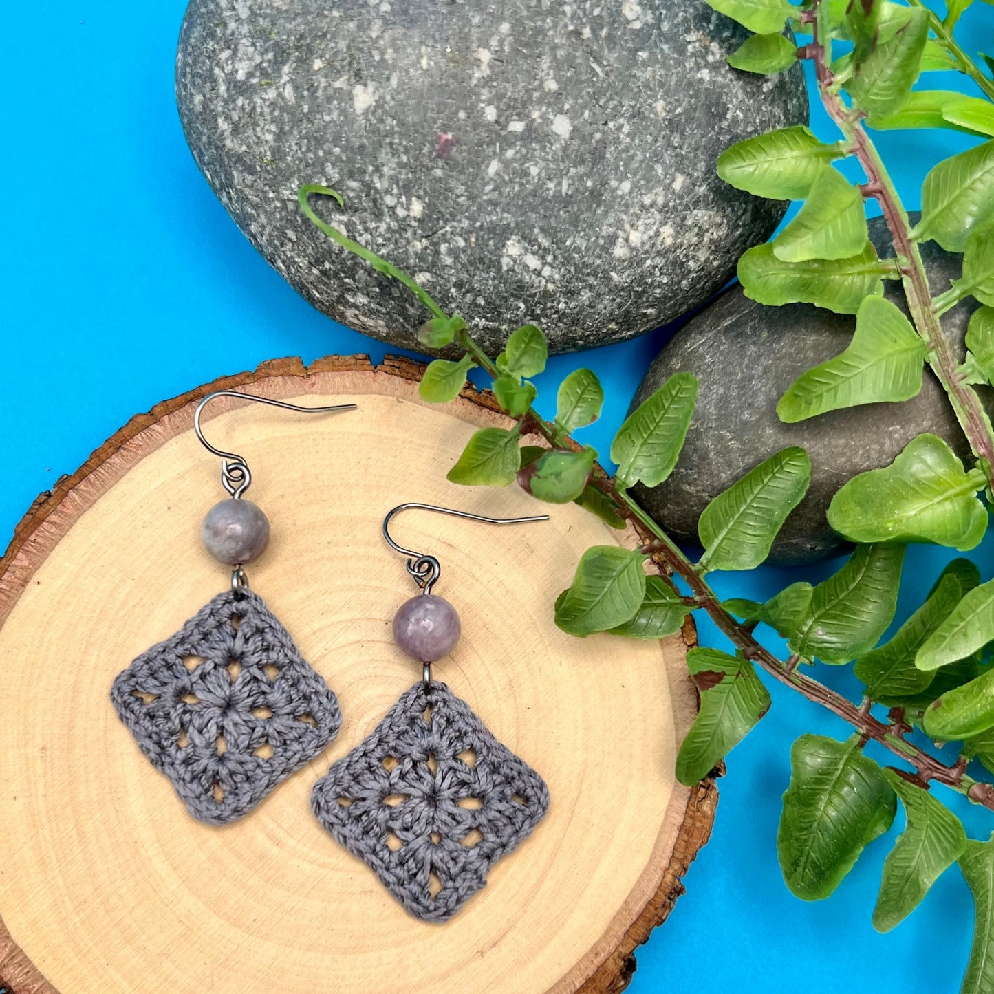 dark gray square crocheted earrings with lilac stone