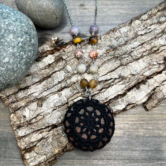 black crocheted pendant on beaded charin with natural stones