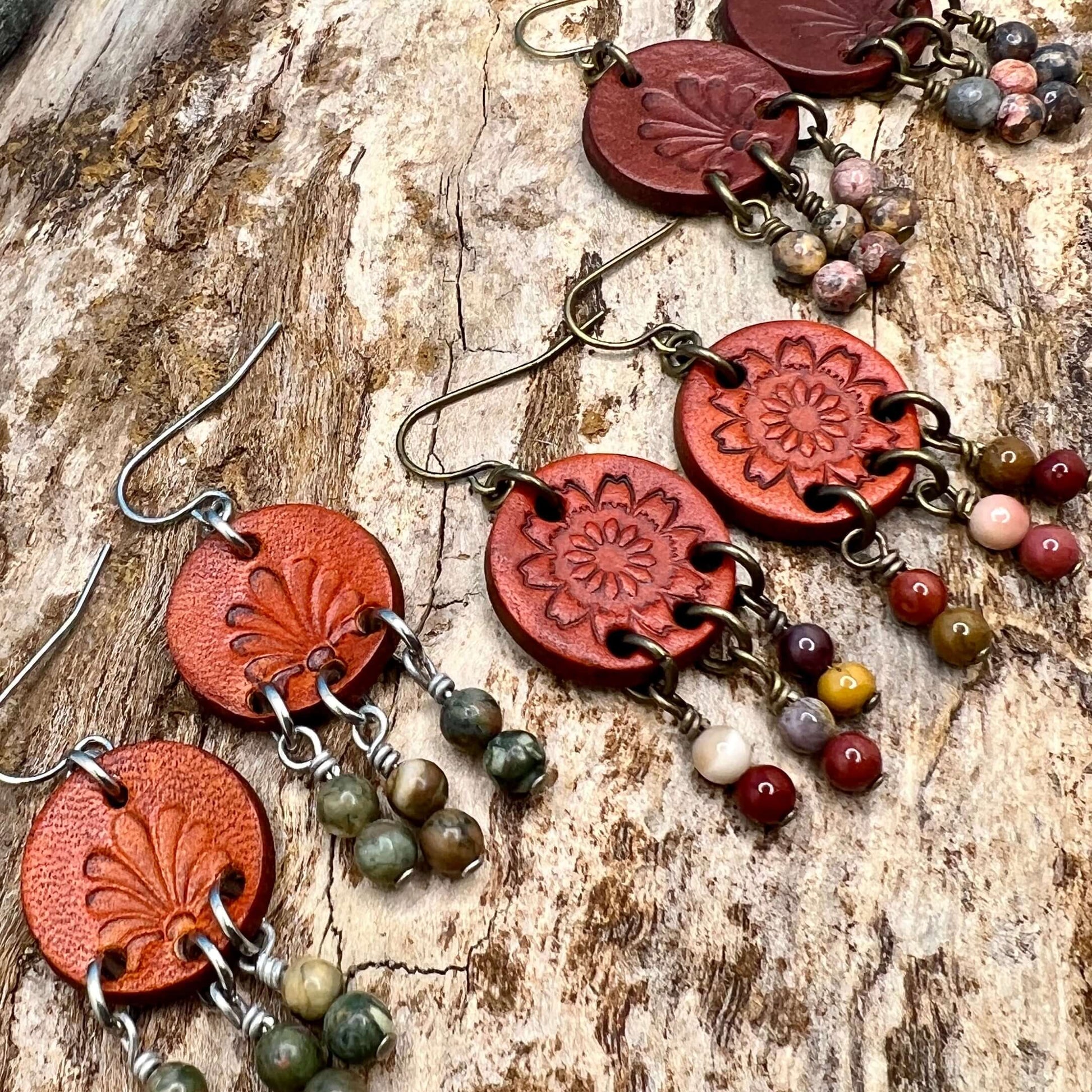 Leather Coin Earrings with Natural Stone DanglesLeather coin earrings are cut from genuine veg tanned leather, stamped and dyed in a antiqued saddle tan or dark brown. Accented with a trio of natural stone dangles these rustic bohemian style compliments a