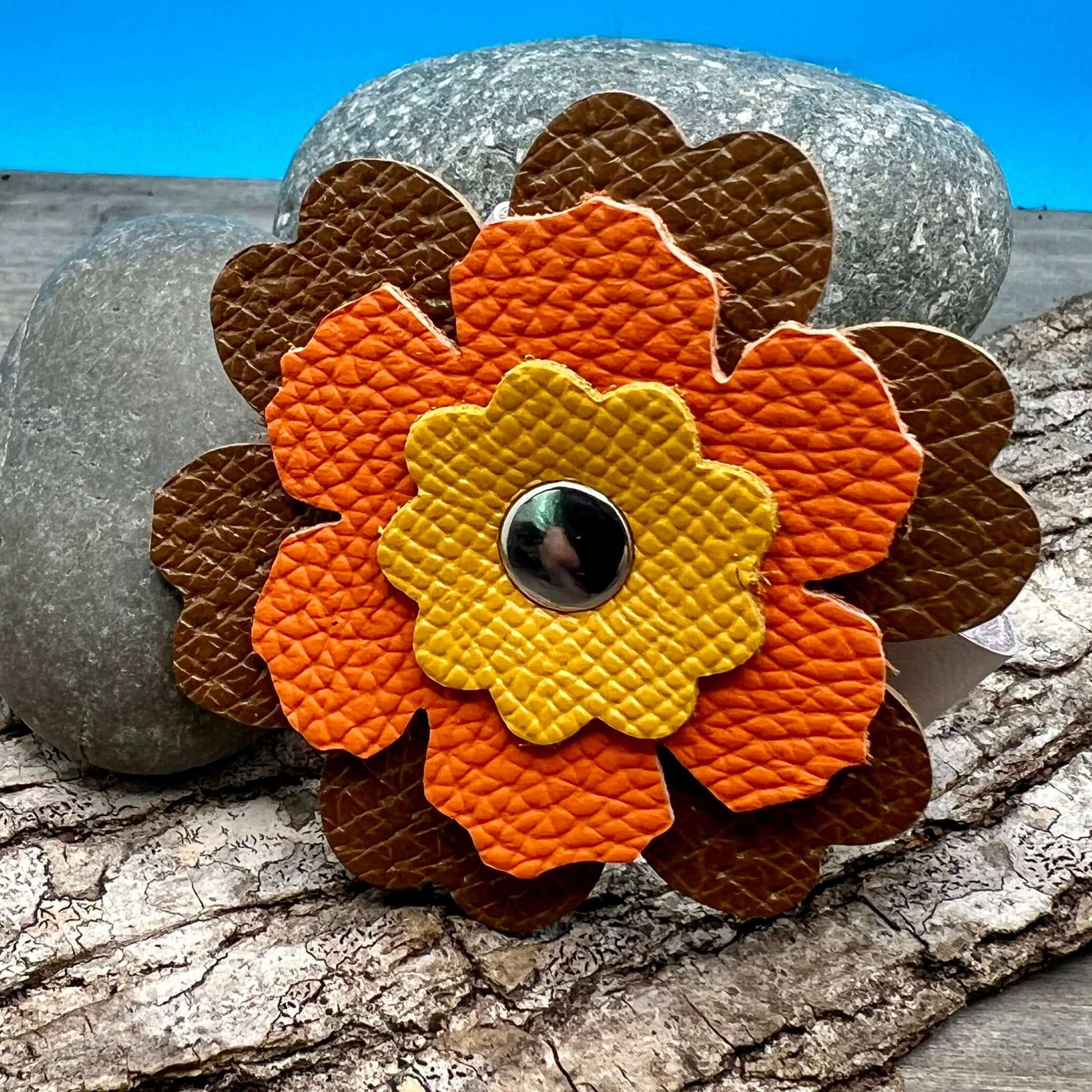 Scarf Cuff - Leather Flowers For Shawls and ScarvesHandcrafted from premium leather, this scarf cuff is a beautiful way to elevate any outfit. Featuring a colorful layered flower, it easily attaches to shawls, scarves, or handbags. Flowers are between 2.2