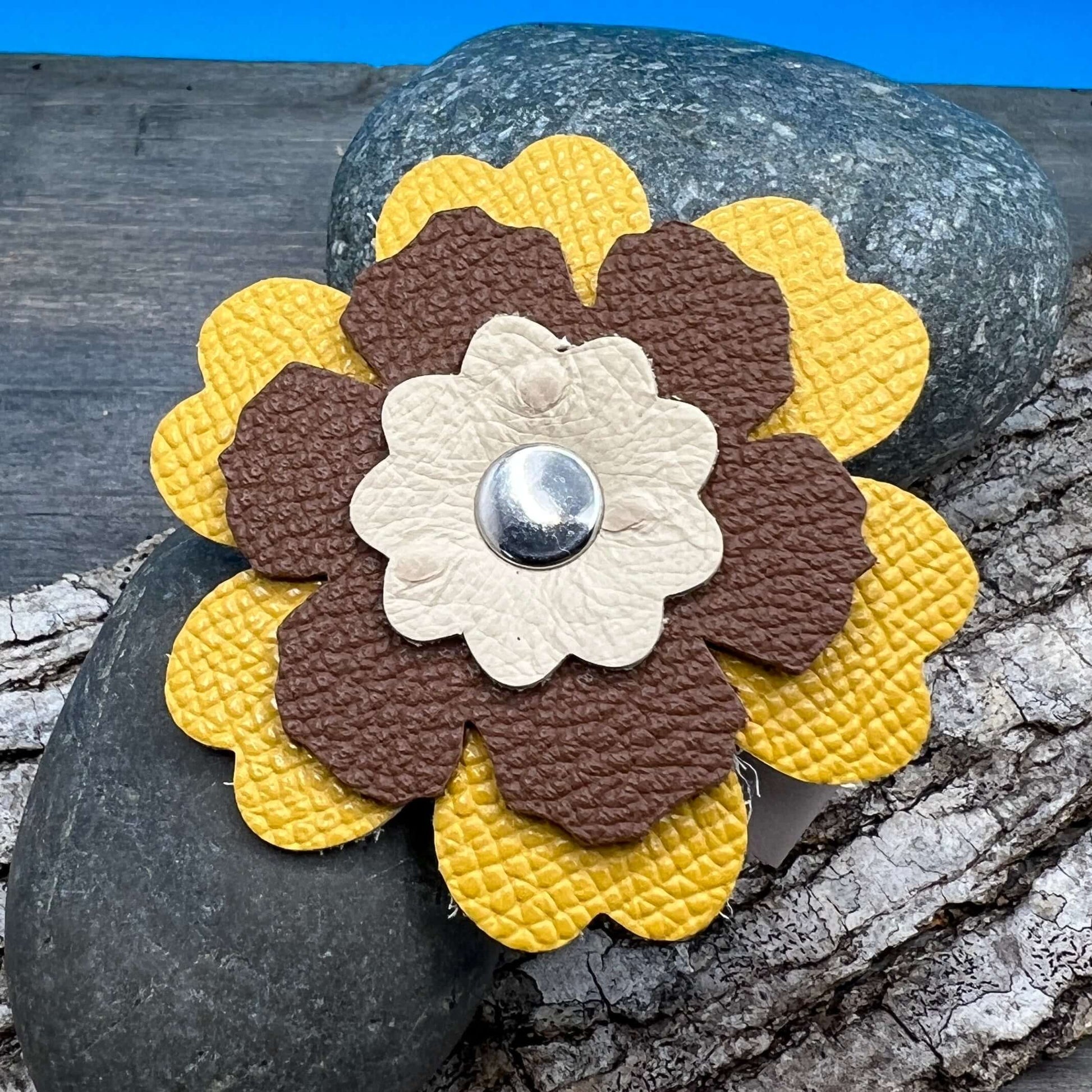 Scarf Cuff - Leather Flowers For Shawls and ScarvesHandcrafted from premium leather, this scarf cuff is a beautiful way to elevate any outfit. Featuring a colorful layered flower, it easily attaches to shawls, scarves, or handbags. Flowers are between 2.2