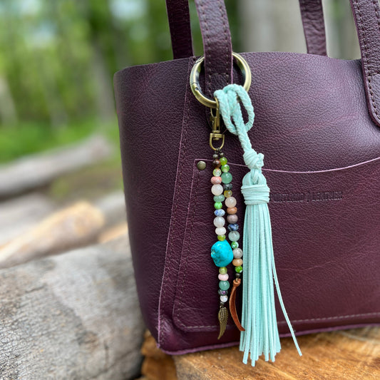 beaded purse charm on purple purse with mint blue tassel