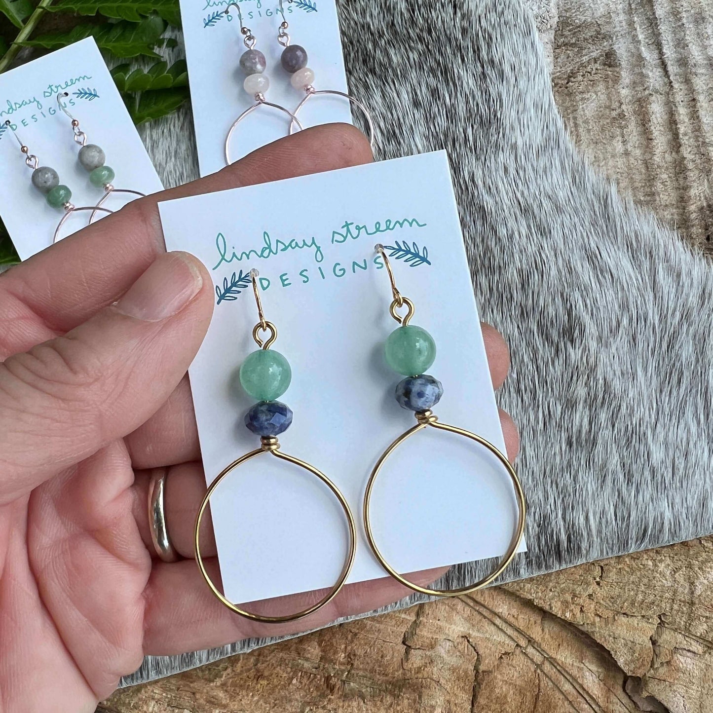 Festival Hoop Earrings - Golden with Blue Sky Jasper & Green AventurineLight and airy hoop earrings are the perfect compliment to your festival style. Hand formed hoops are made with tarnish resistant enameled copper wire in golden and accented with a pai