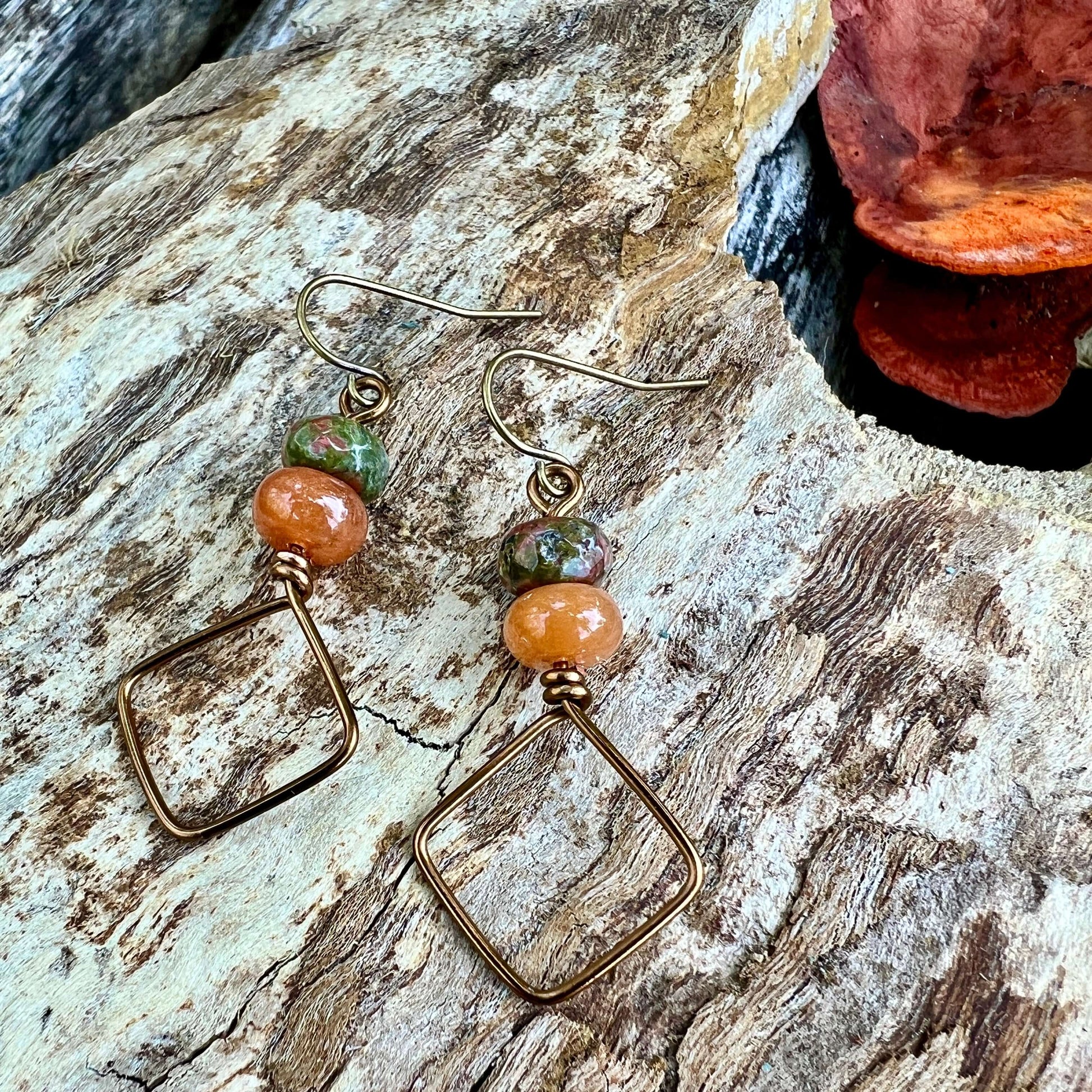 Square Hoop Earrings - Bronze with Unakite and AventurineSimple and chic vintage bronze dangle hoop earrings are perfect for everyday style. Crafted with tarnish resistant enameled copper wire and accented with colorful natural stones. .75" diameter hoop