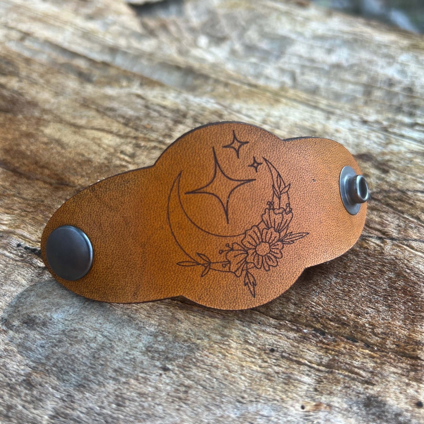 Bandana Slide - Vintage Tan Leather - Moon and StarsSimple and chic leather bandana slide. Classic style snaps on or slides over light weight scarves and bandanas. 3.75" long and 1.75" wide. Snaps at 3" Genuine veg tanned leather laser cut and engraved. D