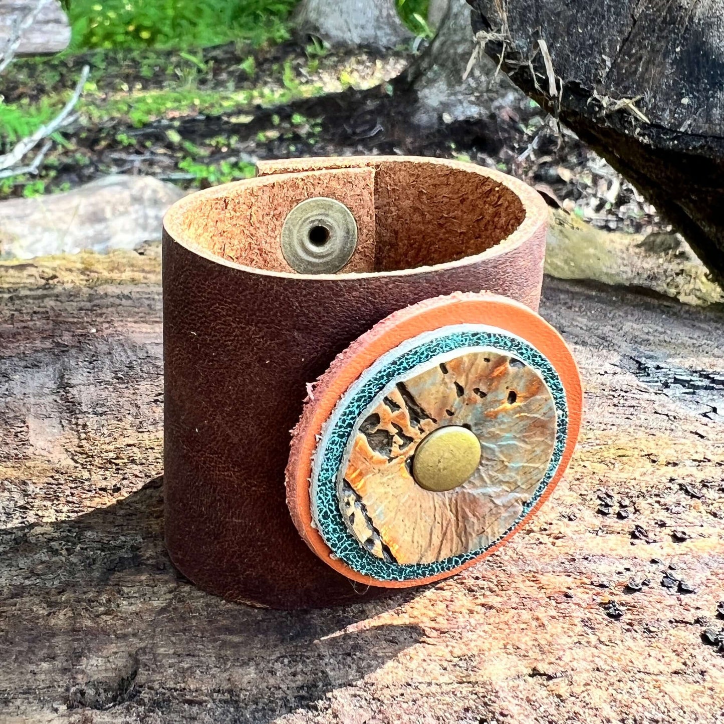 Scarf Cuff for Winter Scarves and Shawls - BrownAccessorize your scarf with a leather scarf cuff. Crafted with genuine leather and accented with a layered leather circle. Double snap closure for a secure wear. 2" wide and snaps closed between 5.5 and 6" F