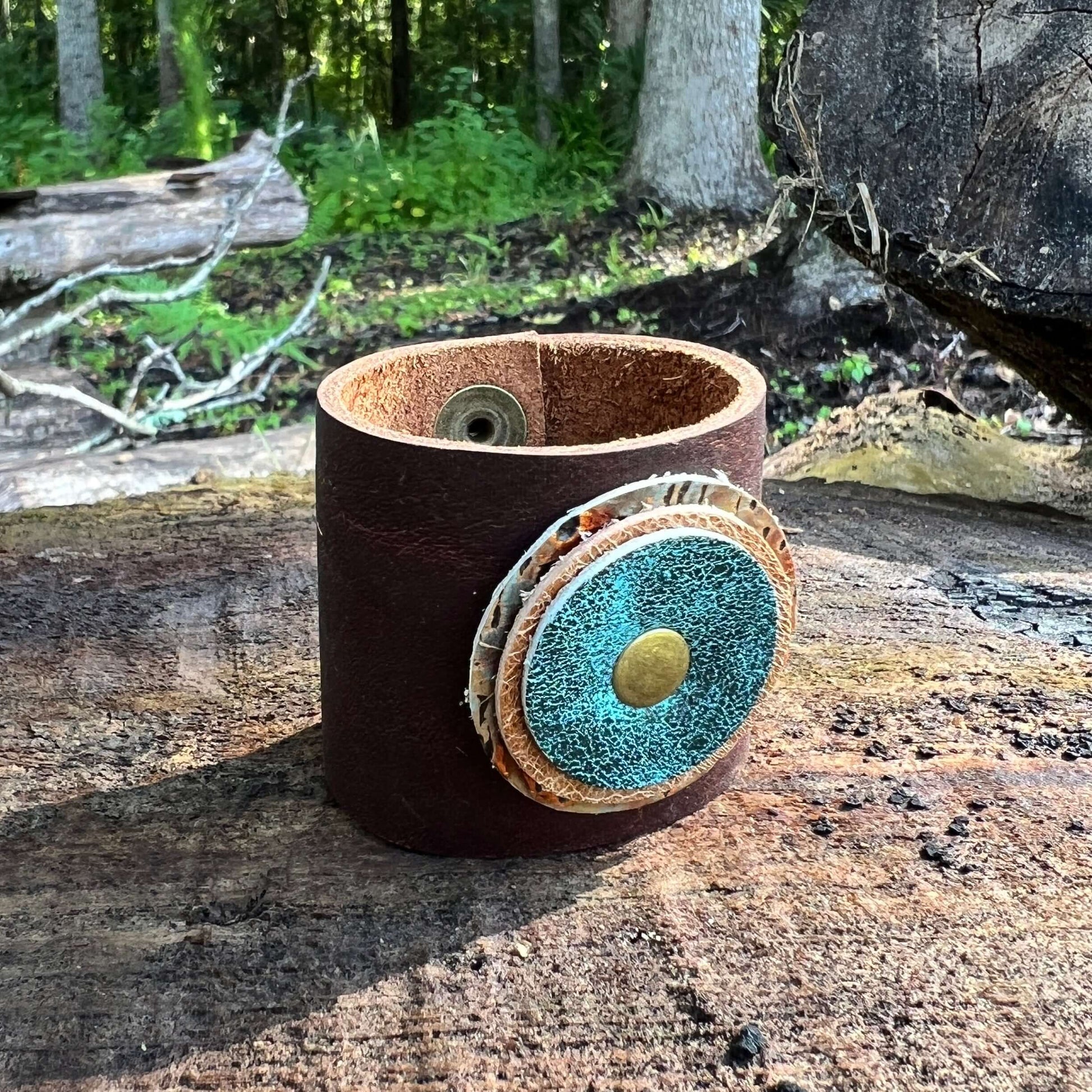 Scarf Cuff for Winter Scarves and Shawls - BrownAccessorize your scarf with a leather scarf cuff. Crafted with genuine leather and accented with a layered leather circle. Double snap closure for a secure wear. 2" wide and snaps closed between 5.5 and 6" F